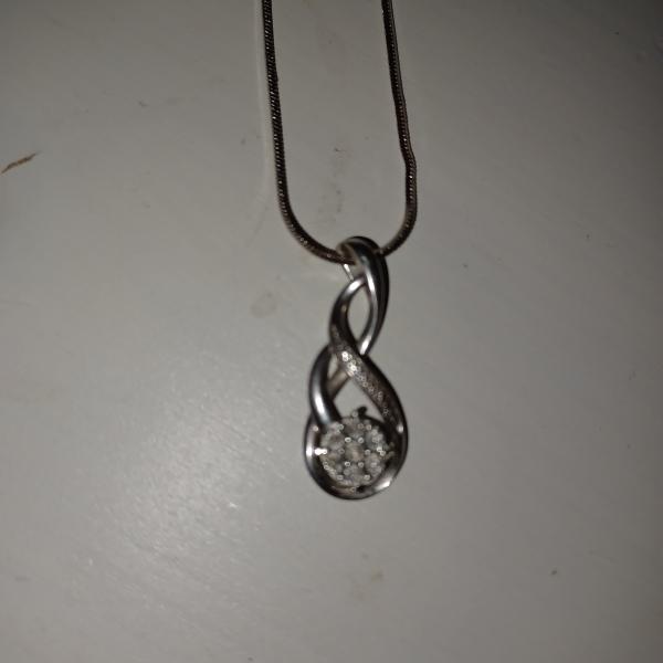 Photo of Kays jewelers necklace with diamond pendent and 1 with diamonds and a pearl