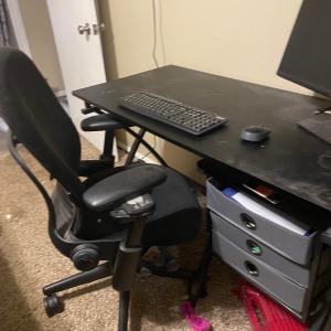 Photo of Desk, chair, file drawers, and monitor. 