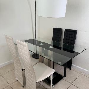 Photo of 4 Chairs Glass Table and Lamp setup  living room 