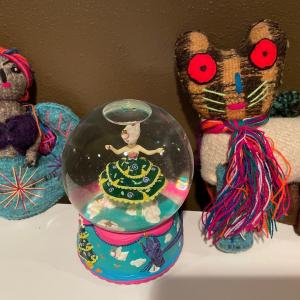 Photo of Snow globe and bright knitted items