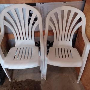 Photo of 2 White Plastic Chairs