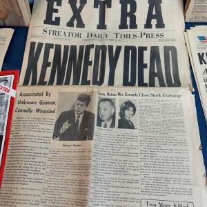 Photo of Lot 122 collection of newspapers regarding JFK assassination