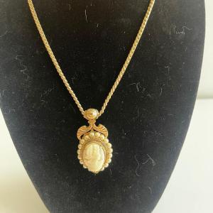Photo of Cameo necklace with faux pearls. Cameo is 1-1/2 inches. Necklace is 18”.