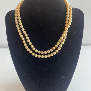 Photo of Double strand faux pearls. . 26” long.