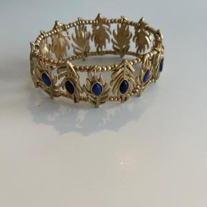 Photo of Gold tone stretch 8” leaf look bracelet. With faux sapphires .