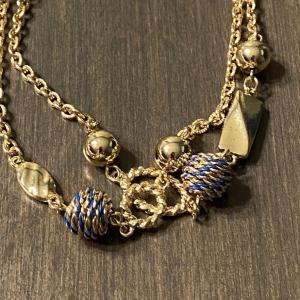 Photo of 22” adjustable gold tone necklace with blue & gold pinecones.
