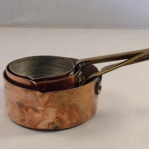 Photo of Set of Four Graduated Copper Measuring Cups