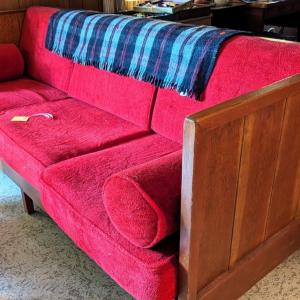 Photo of Red sofa. Loose cushions. Wood frame