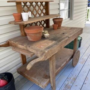 Photo of Wooden Potting Bench and Terracotta Planters