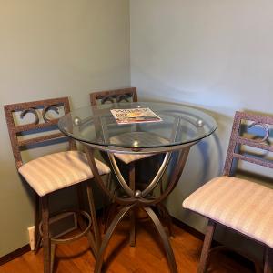 Photo of Glass pub table 4 chairs and matching wine shelf