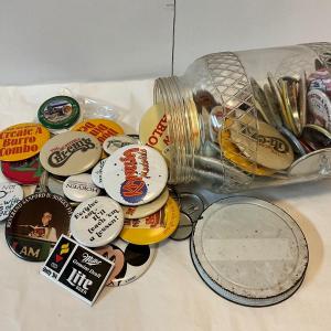 Photo of Vintage jar with multiple collection of pins