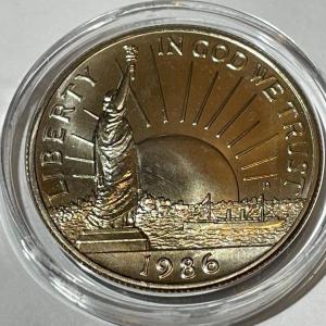Photo of 1986-D CHOICE BU Statue of Liberty Commemorative Half Dollar in a Mint Capsule.