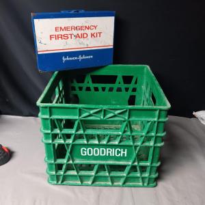 Photo of HEAVY PLASTIC MILK CRATE AND A METAL FIRST-AID KIT WITH SOME CONTENTS