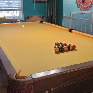 Photo of Wood Pool Table and Hanging Light