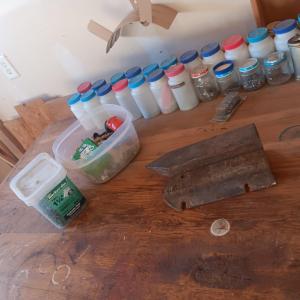Photo of PLASTIC BOTTLES OF HARDWARE AND A HOMEMADE ANVIL