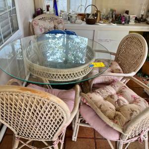 Photo of Wicker and glass patio table set