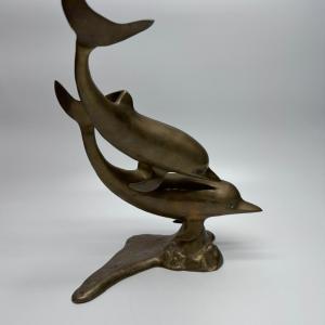 Photo of Brass Swimming Dolphins Statue