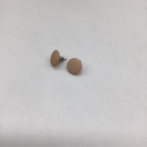 Photo of Tan colored round earrings