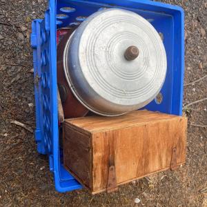 Photo of Blue plastic crate with various metal and glass lids, wooden box, etc.