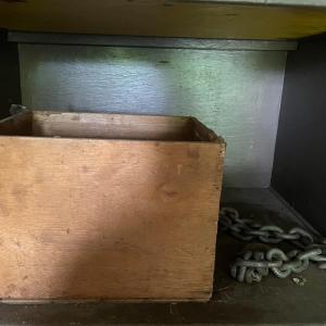 Photo of Wood box with various chains and metal tub