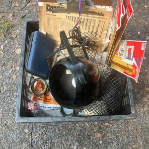 Photo of Black plastic crate with light, clipboard, tools, etc