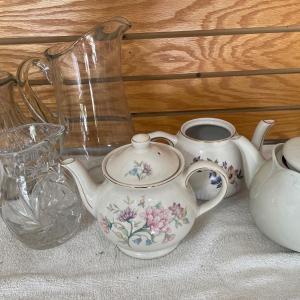 Photo of Clear glass water pitcher and teapots