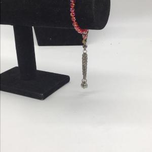 Photo of Red beaded bracelet with heart dangle charm