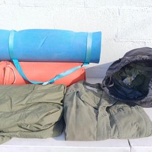 Photo of Military issued sleeping bag. - bed cushions - coveralls - and a waterproof mili
