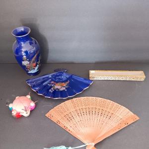 Photo of Blue vase with porcelain fan dish a wood varved fan and a vintage circle of frie