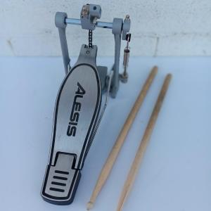 Photo of Alesis chain Kick Drum Pedal with a pair of drumsticks