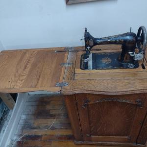 Photo of Antique Cast Body Minnesota Treadle Sewing Machine in Oak Cabinet