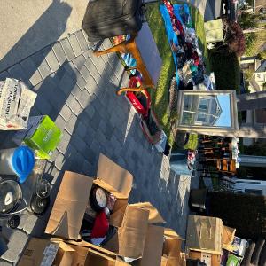 Photo of Yard sale with clothes kitchen wares dresser and more
