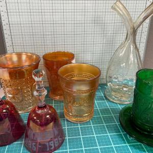 Photo of Carnival glass, green glass, bells and decanter