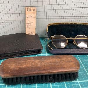 Photo of Vintage eye glasses, wallet and shoe brush