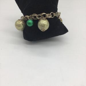 Photo of Green dangle charms on charm bracelet