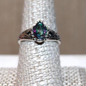 Photo of Size 8¾ Oval Shaped Green/Purple Irridescent Stone Ring on a Silver Tone Band (