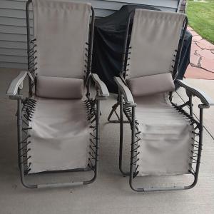 Photo of Two comfy fold away lounge reclining patio chairs that are sure to be a great na
