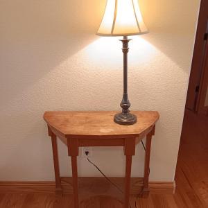 Photo of Antique wooden flat backed entry-way table with electric black accent lamp