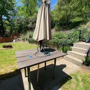 Photo of Wood and Metal Patio Table with Umbrella
