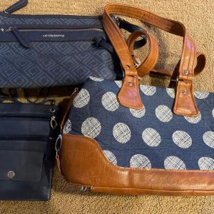 Photo of 2 navy hand bags and small cross body bag