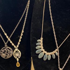 Photo of 4 different silver tone necklaces