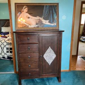 Photo of chest of drawers and painting