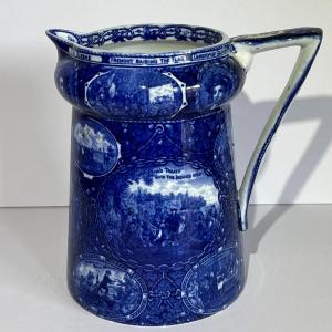 Photo of ROWLAND MARSELLUS HISTORICAL POTTERY PITCHER IN BLUE & WHITE WITH VIGNETTES OF V