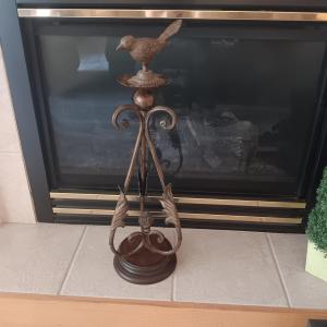Photo of TALL METAL PILLAR CANDLE HOLDER WITH AN ADDED CAST IRON BIRD