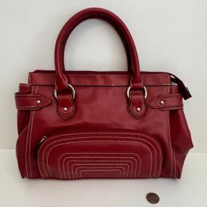 Photo of Red leather handbag with adjustable Straps