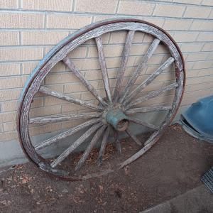 Photo of ANTIQUE WAGON WHEEL WITH WOOD SPOKES AND IRON RIM AND HUB