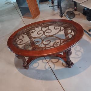 Photo of OVAL COFFEE TABLE WITH GLASS TOP AND METAL ACCENTS
