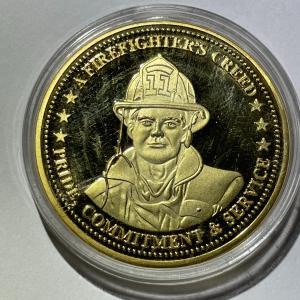 Photo of A Firefighter's Creed Commemorative Coin Encircled by the creed "Pride, Commitme