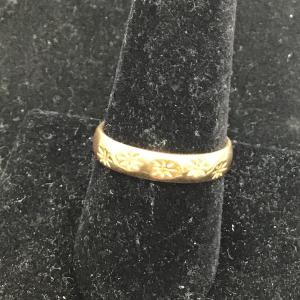 Photo of Gold toned ring with flower designs