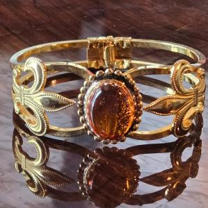 Photo of Hinged Gold Tone Bracelet with an Amber Colored Stone
